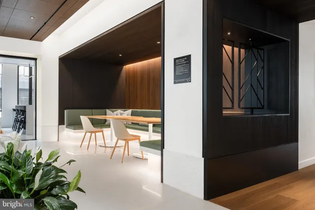a view of a livingroom with furniture and floor to ceiling window