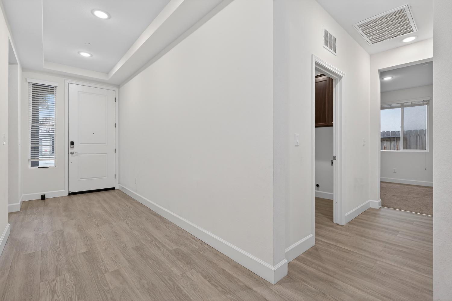 2340 Bellows Way Lodi, CA 95242 - Photo 11 of 42 an empty room with wooden floor & windows