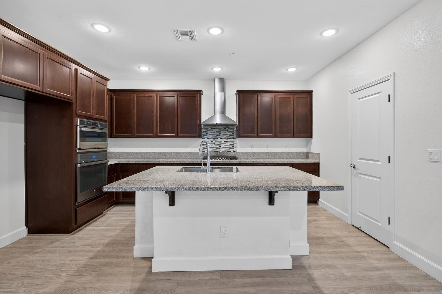 2340 Bellows Way Lodi, CA 95242 - Photo 16 of 42 a kitchen with stainless steel appliances granite countertop a sink and a refrigerator