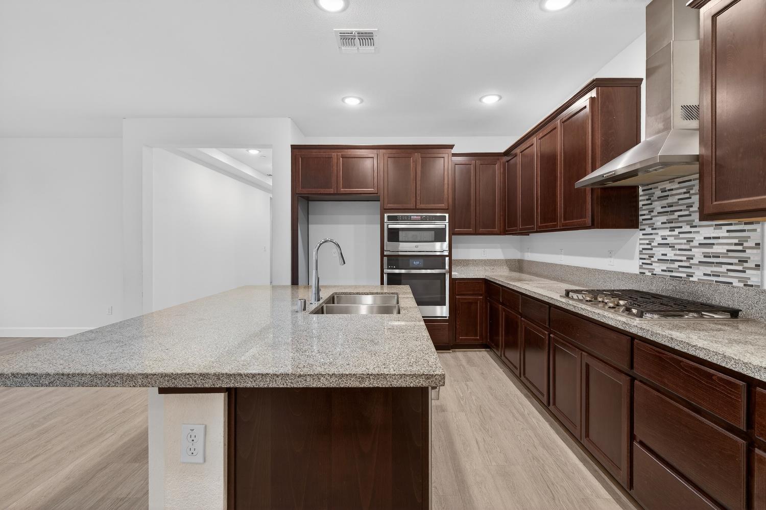 2340 Bellows Way Lodi, CA 95242 - Photo 17 of 42 a kitchen with stainless steel appliances granite countertop a sink stove and refrigerator