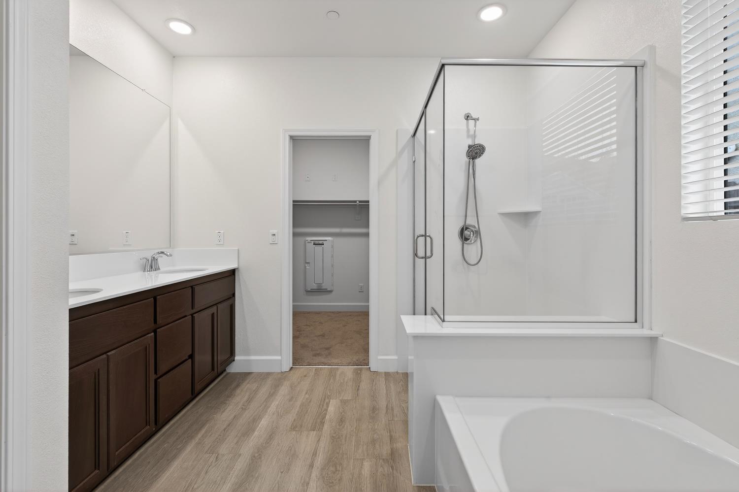 2340 Bellows Way Lodi, CA 95242 - Photo 29 of 42 a bathroom with a double vanity sink a mirror and a bathtub