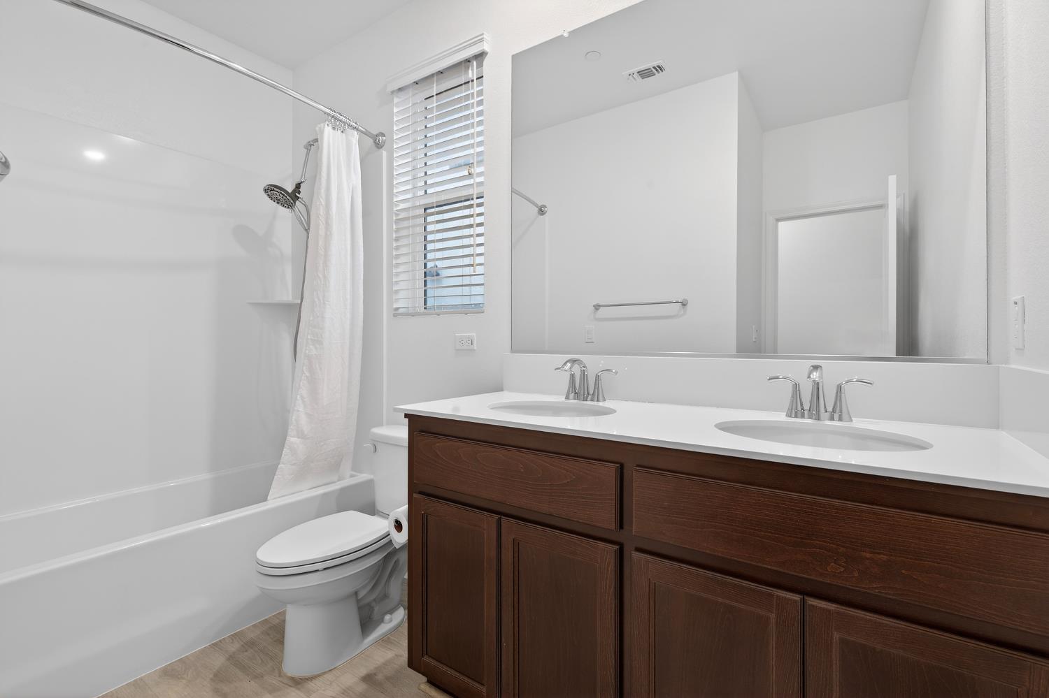 2340 Bellows Way Lodi, CA 95242 - Photo 7 of 42 a bathroom with a toilet a sink a mirror a bathtub and vanity