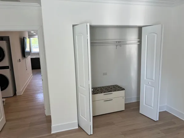 a kitchen with a refrigerator and wooden floor