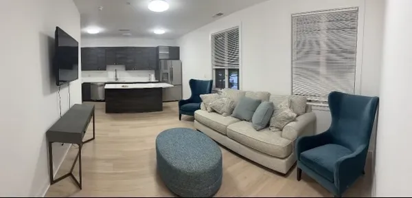 a living room with furniture and a flat screen tv