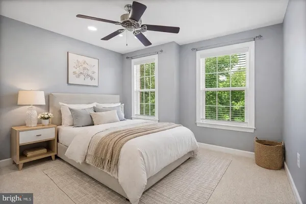 a bedroom with a large bed and window