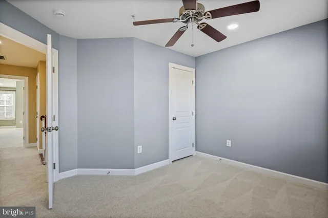 an empty room with chandelier fan