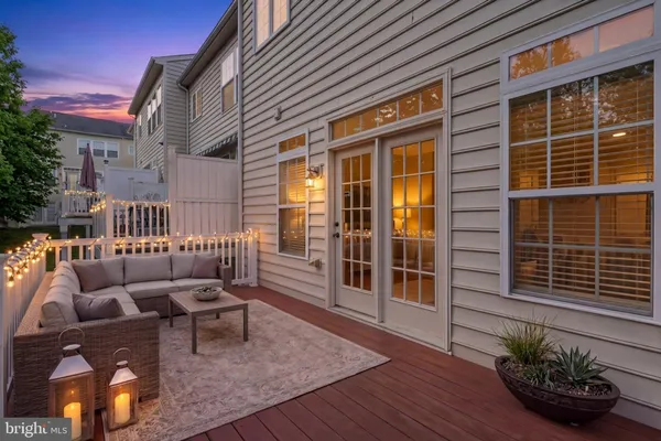 a balcony with furniture and wooden floor
