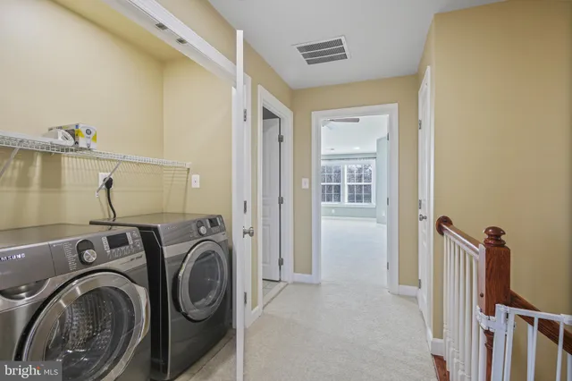 a view of a hallway with washer and dryer