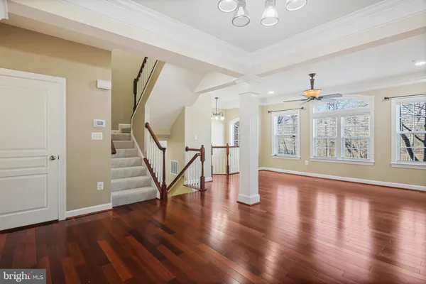 a view of an entryway with wooden floor and a livingroom view