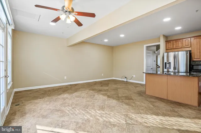 a view of a kitchen with a sink and a refrigerator