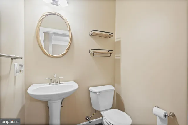 a bathroom with a toilet sink and mirror