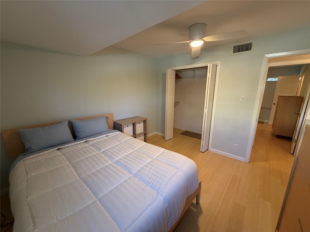 300 Crockett Street, Unit 201 Austin, TX 78704 - Photo 13 of 32 a bedroom with a bed and a flat tv screen on dresser