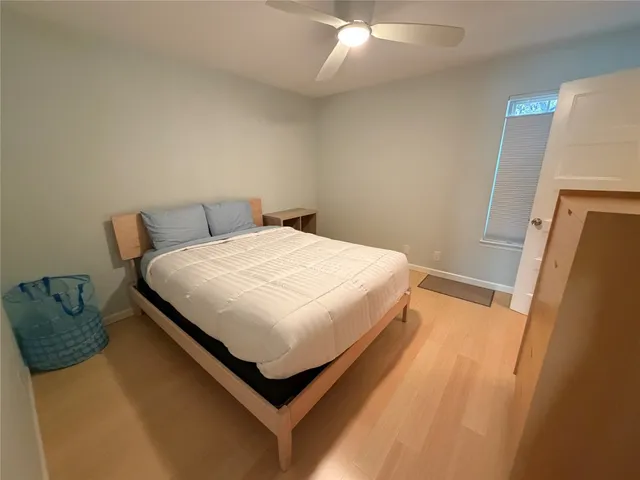 a bed sitting in a bedroom next to a window