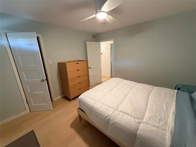 a bedroom with a bed and a dresser