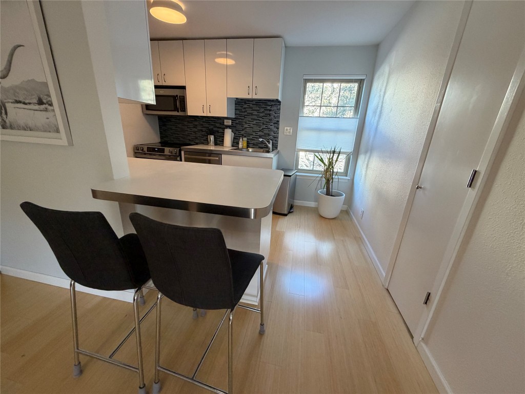 300 Crockett Street, Unit 201 Austin, TX 78704 - Photo 2 of 32 a living room with furniture and a wooden floor