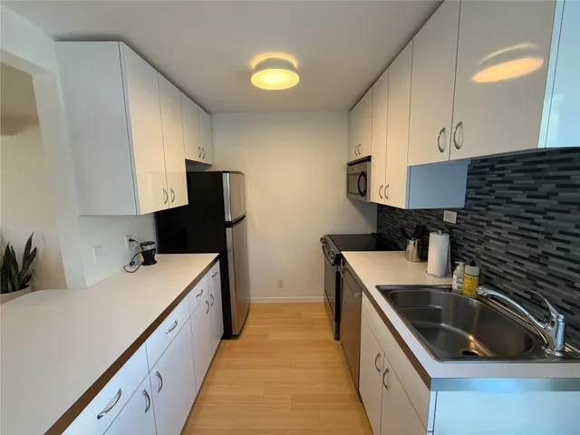 a kitchen with a sink and cabinets