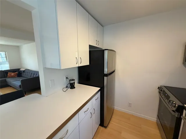 a kitchen with a sink a refrigerator and washer