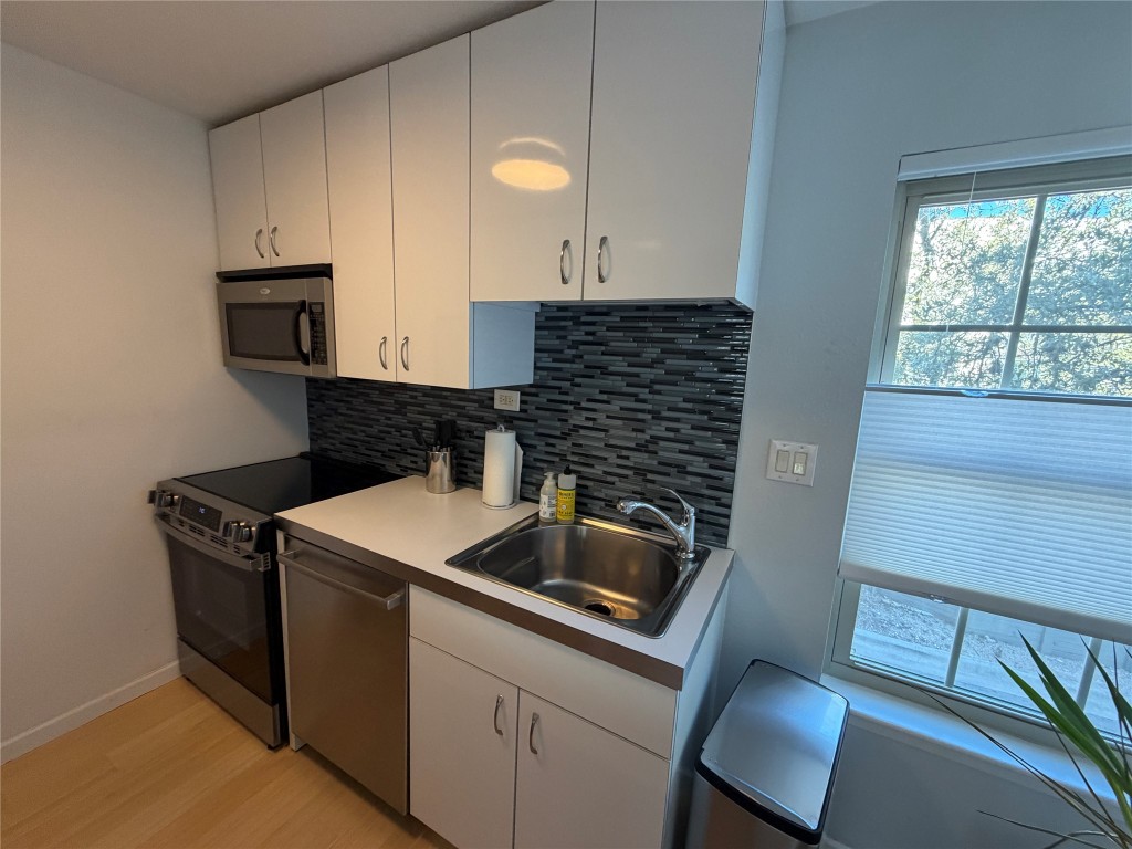 300 Crockett Street, Unit 201 Austin, TX 78704 - Photo 7 of 32 a kitchen that has a sink and a stove