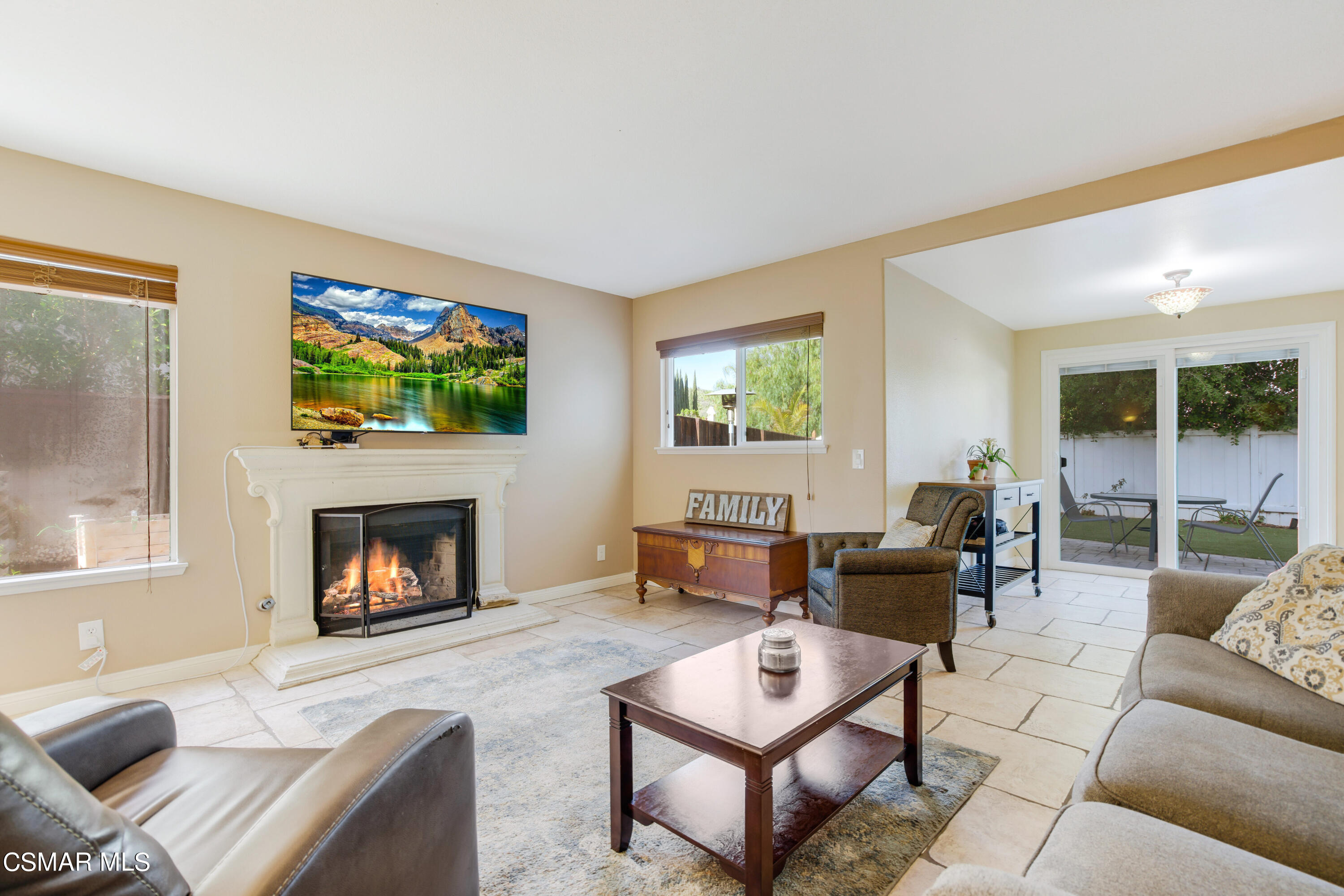 486 Fresh Meadows Road Simi Valley, CA 93065 - Photo 11 of 30 a living room with furniture a flat screen tv and a fireplace