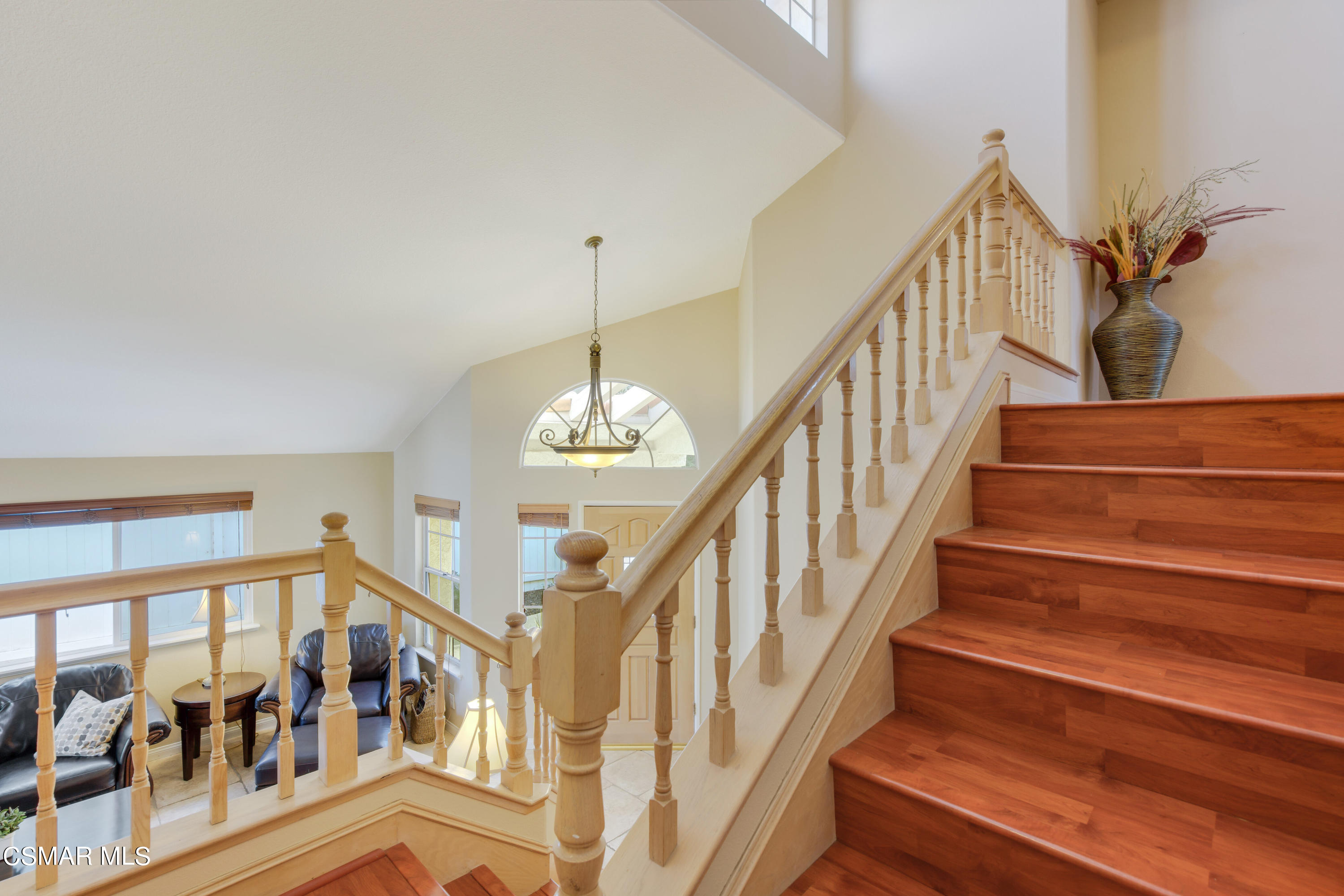 486 Fresh Meadows Road Simi Valley, CA 93065 - Photo 14 of 30 a view of staircase with lots of frames on wall and a chandelier