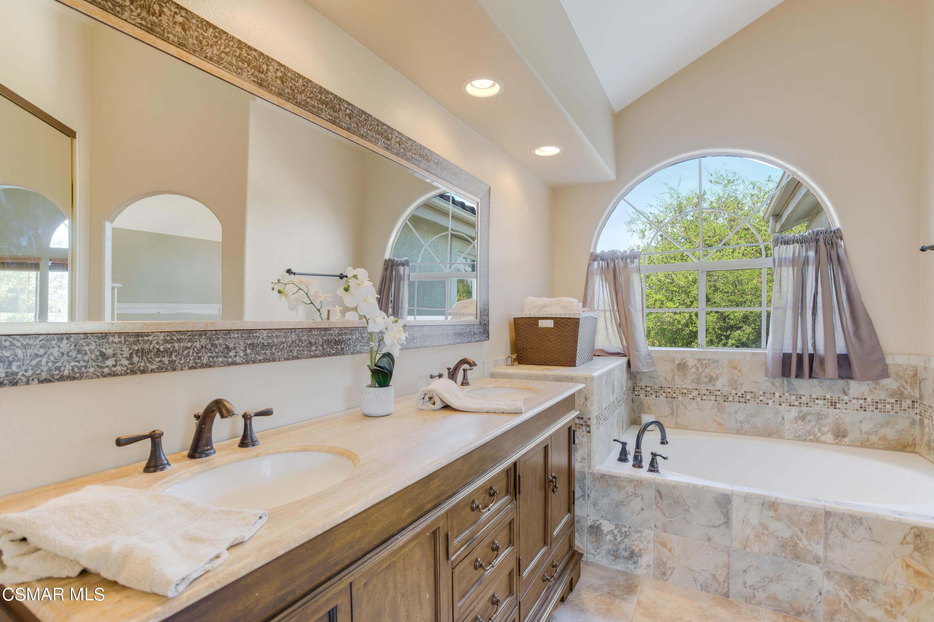 486 Fresh Meadows Road Simi Valley, CA 93065 - Photo 18 of 30 a bathroom with a granite countertop sink and a large mirror
