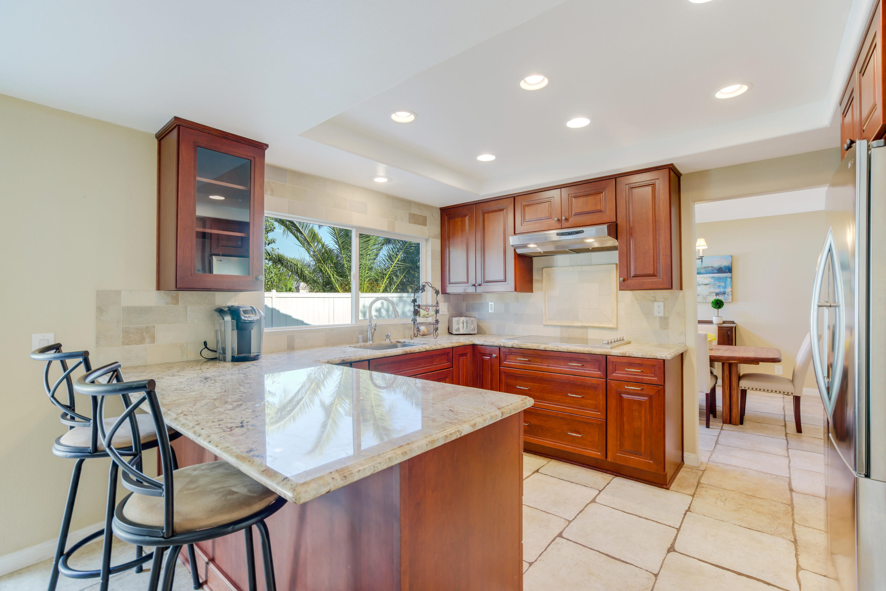 486 Fresh Meadows Road Simi Valley, CA 93065 - Photo 7 of 30 a kitchen with stainless steel appliances granite countertop table chairs sink and cabinets