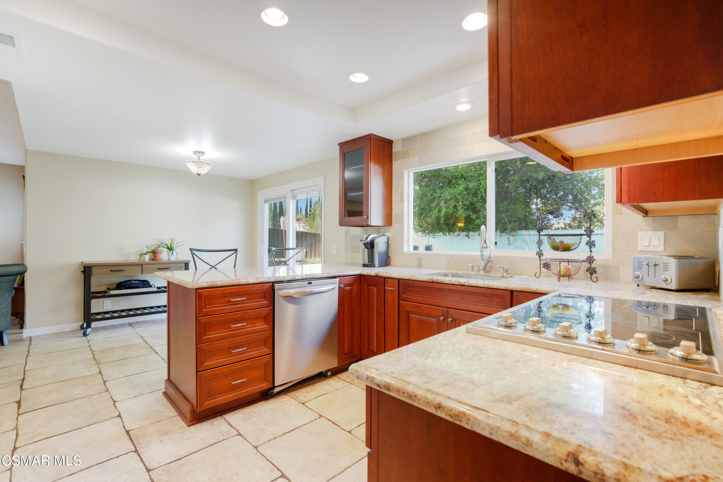 486 Fresh Meadows Road Simi Valley, CA 93065 - Photo 8 of 30 a kitchen with stainless steel appliances granite countertop a sink and dishwasher a stove with wooden cabinets