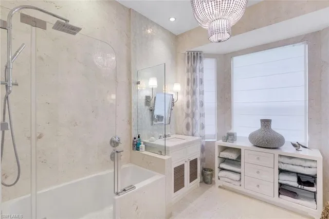 a bathroom with a tub sink shower and mirror