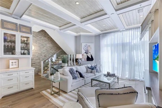 a living room with furniture and large windows