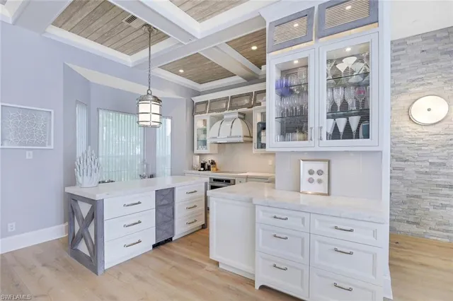 a kitchen with white cabinets and white appliances