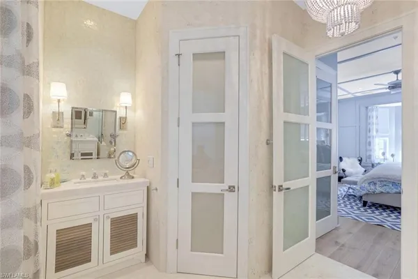 a spacious bathroom with a shower sink and mirror