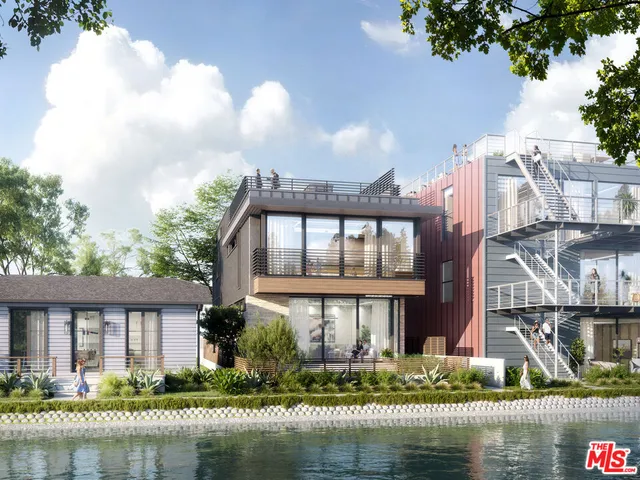 a front view of a house with a yard a fountain and a large tree