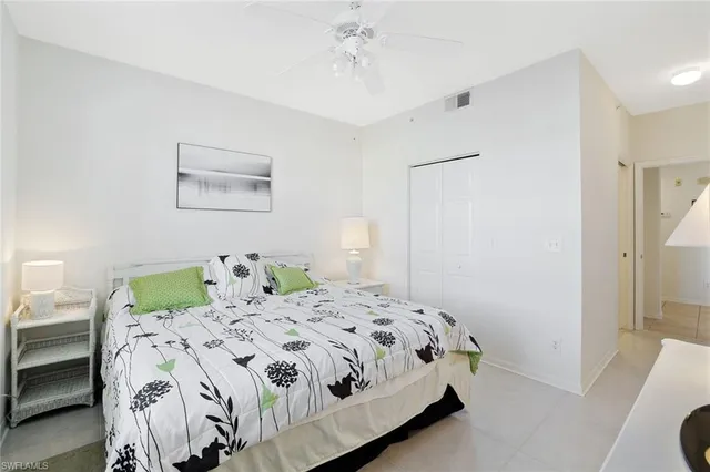 a bedroom with a bed and a lamp