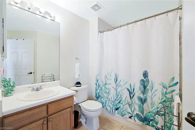 a bedroom with two beds and a window