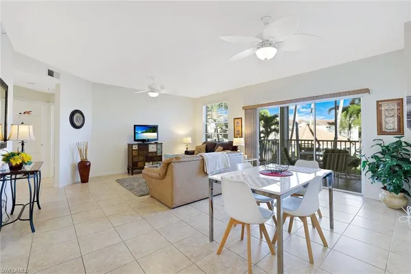 a view of a dining room with furniture and kitchen view