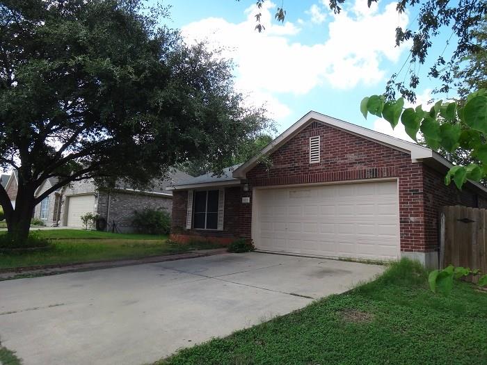 1903 Balsam Way Round Rock, TX 78665 - Photo 18 of 21 A classic brick exterior offers enduring appeal with an attached garage and a mature shade tree.