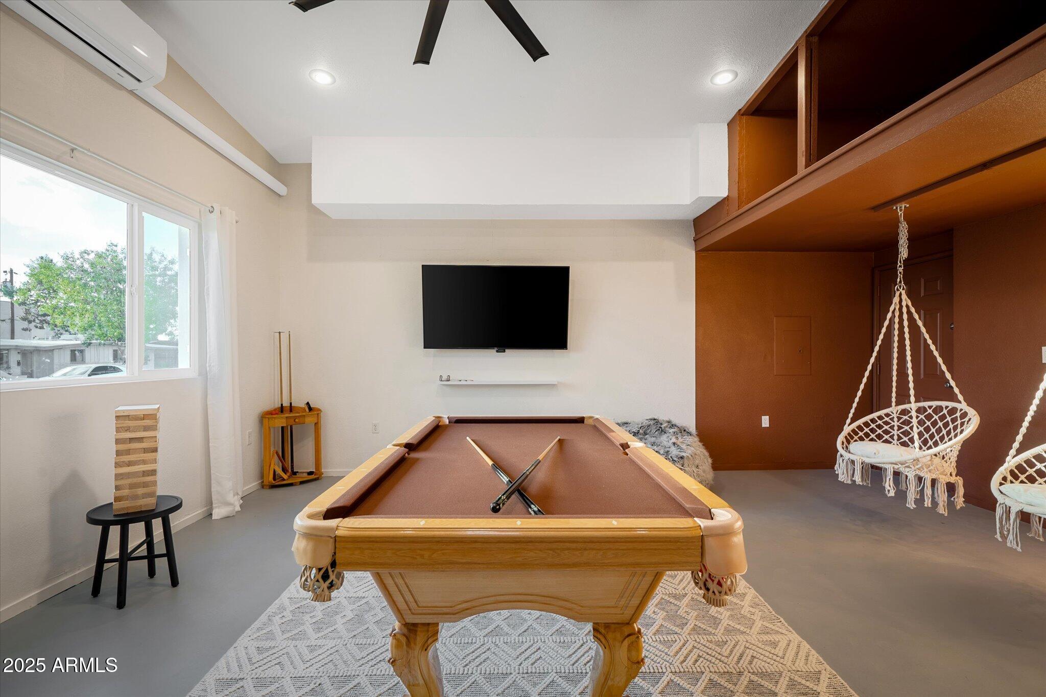 2307 North 51st Place Phoenix, AZ 85008 - Photo 12 of 41 a living room with a couch and a flat screen tv