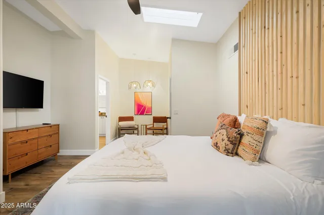 a bedroom with a bed and a flat screen tv