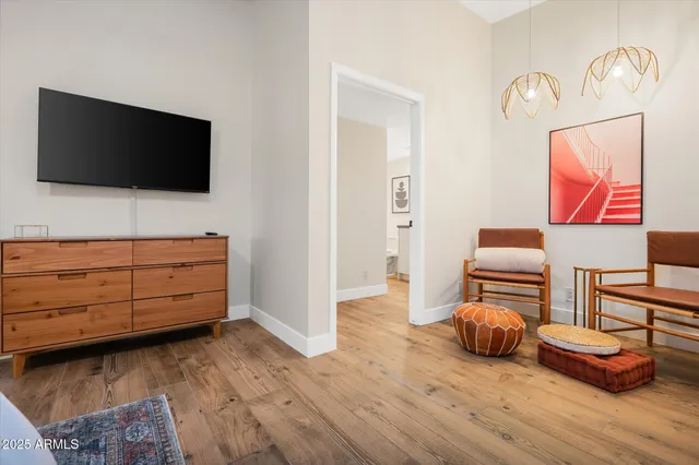 a bedroom with a bed and a potted plant