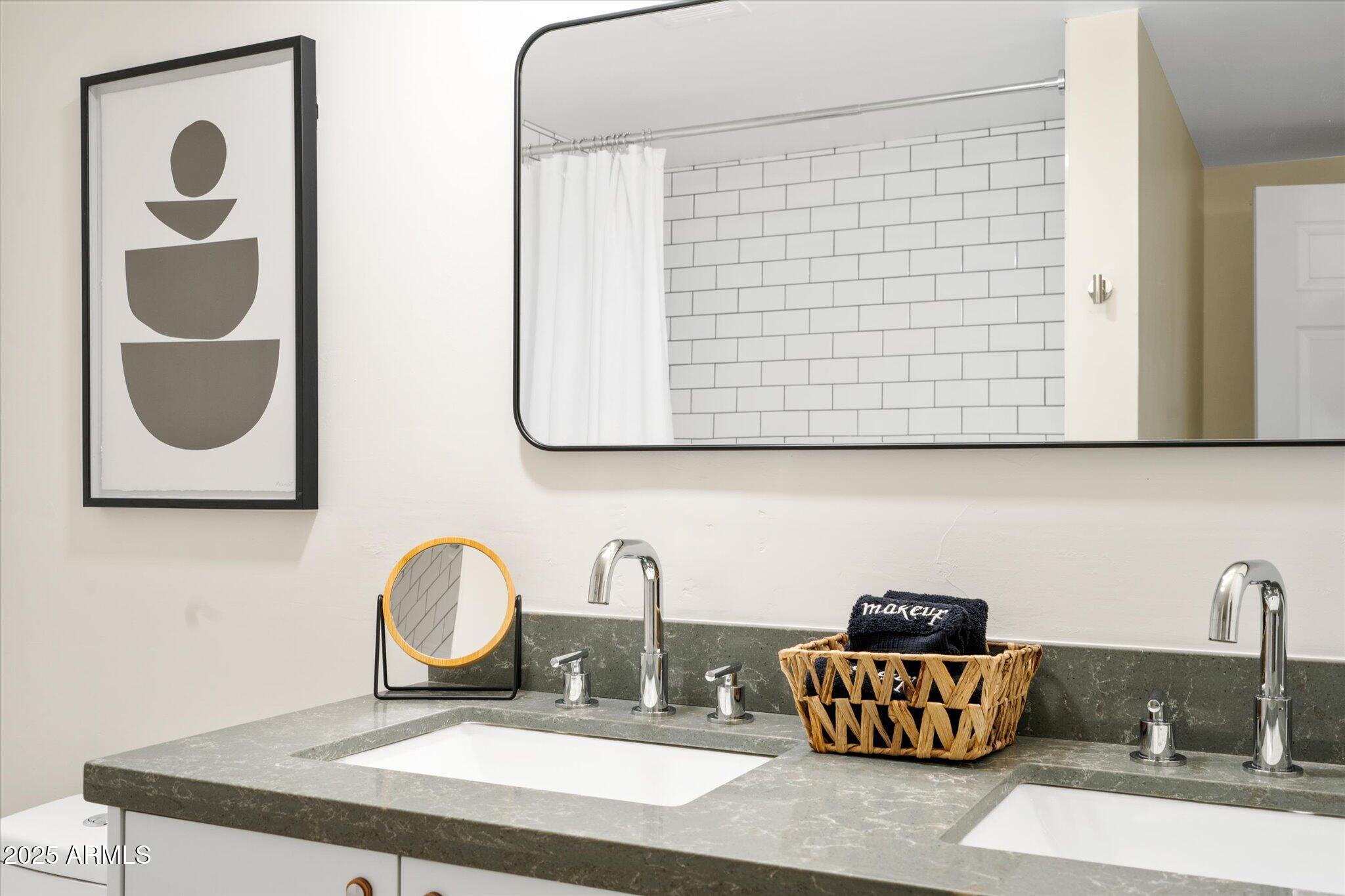 2307 North 51st Place Phoenix, AZ 85008 - Photo 19 of 41 a bathroom with a sink and a mirror