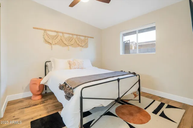 a bedroom with a flat screen tv and a window