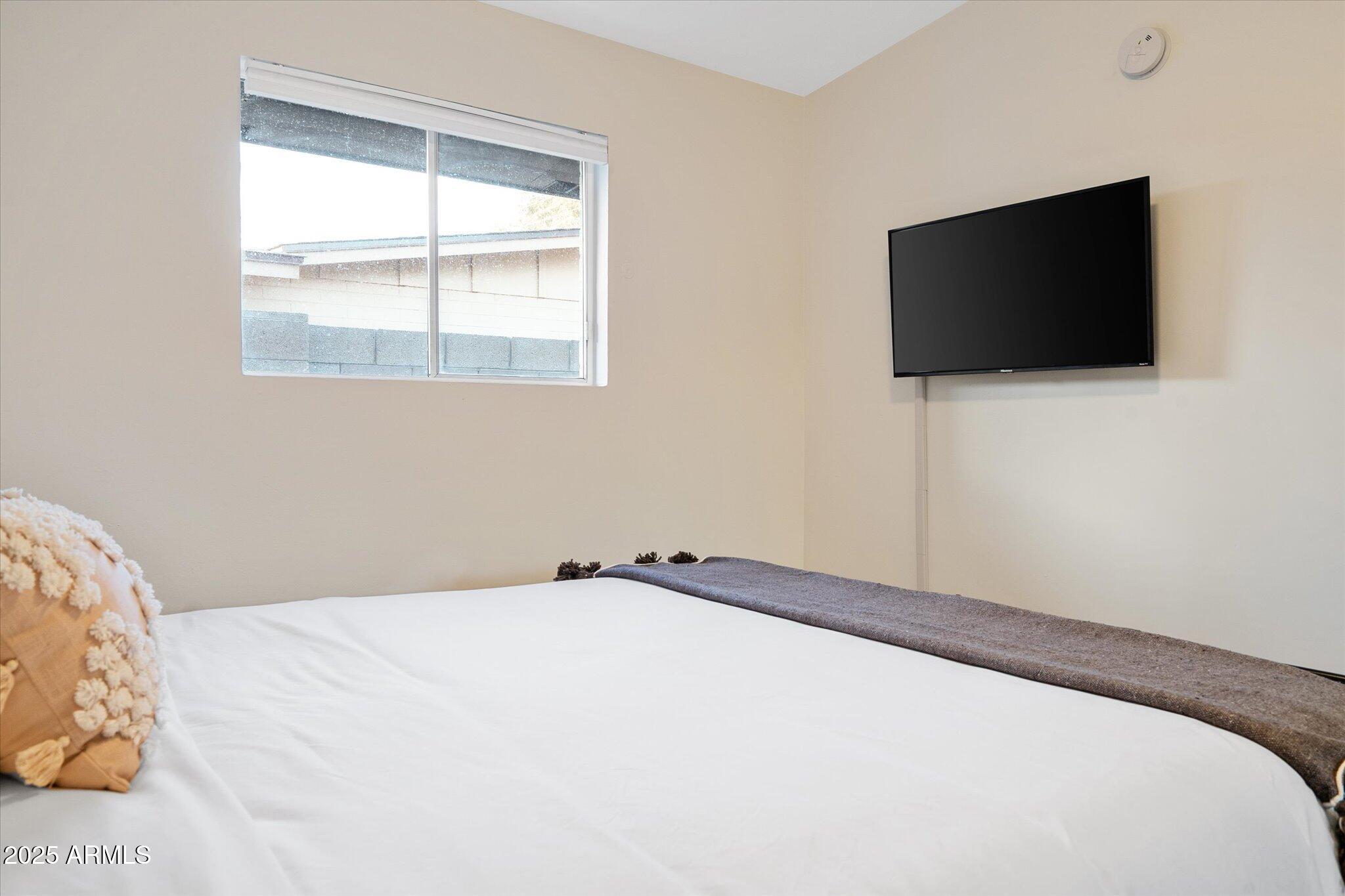 2307 North 51st Place Phoenix, AZ 85008 - Photo 21 of 41 a bedroom with a flat screen tv and a window