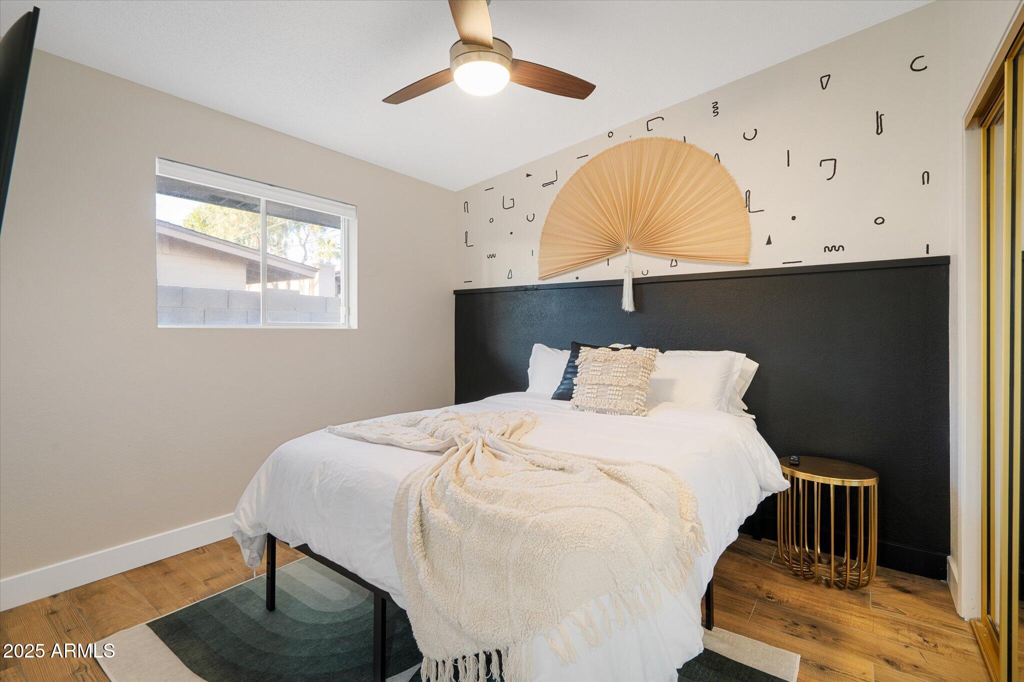 2307 North 51st Place Phoenix, AZ 85008 - Photo 24 of 41 a bedroom with a bed and a chandelier