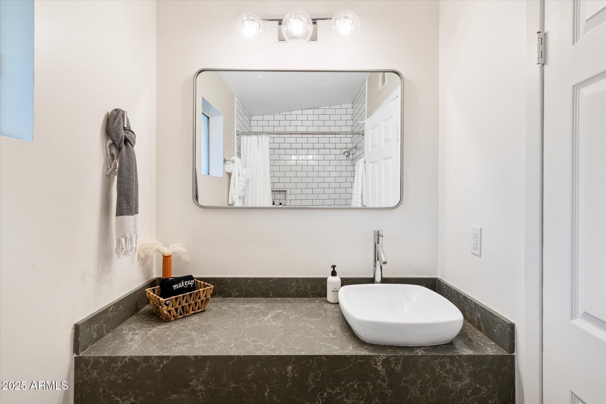 2307 North 51st Place Phoenix, AZ 85008 - Photo 25 of 41 a bathroom with a sink and a mirror
