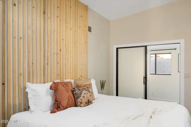 a bathroom with a sink a mirror a toilet and shower