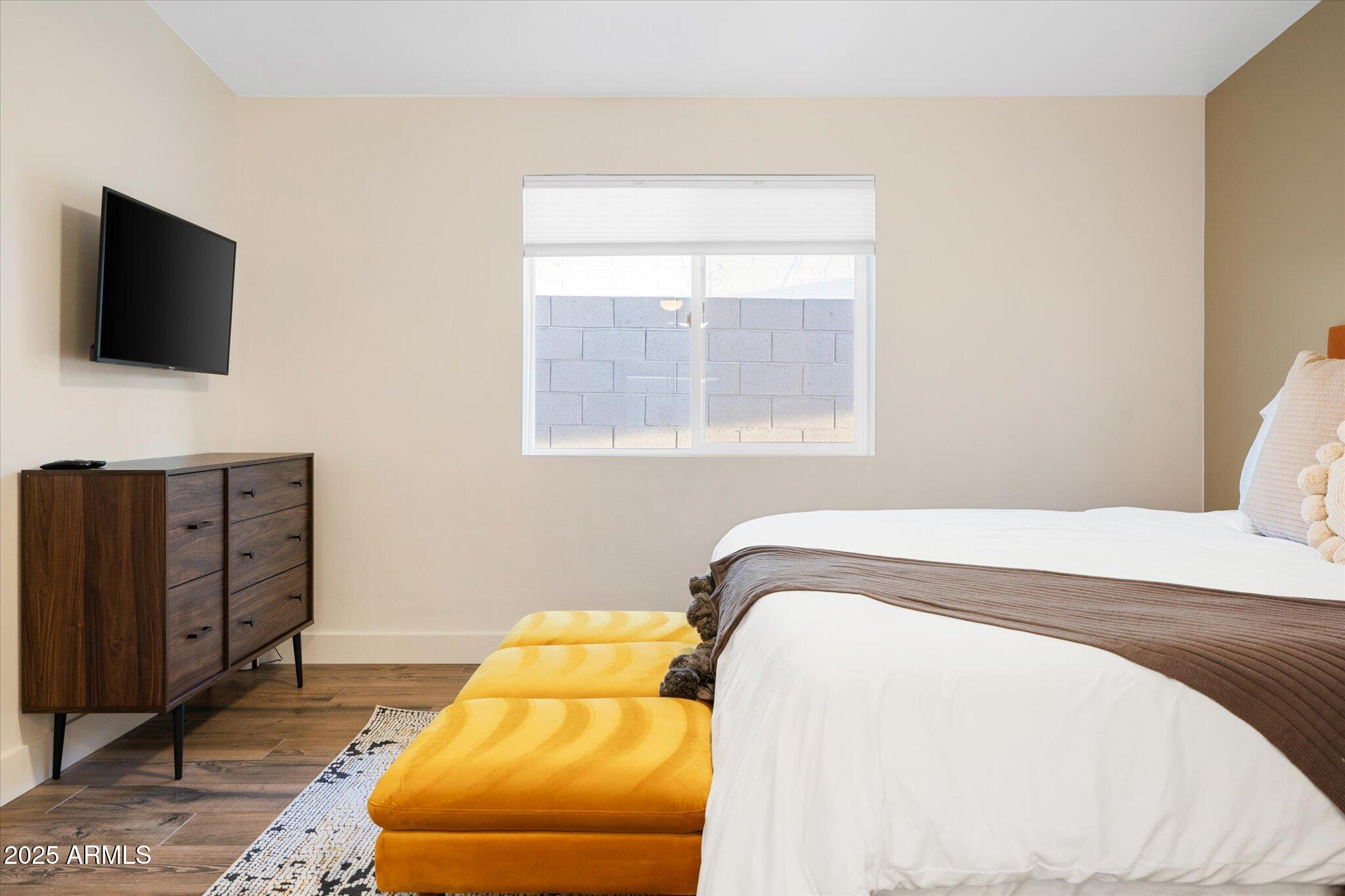 2307 North 51st Place Phoenix, AZ 85008 - Photo 30 of 41 a bedroom with a bed and flat screen tv