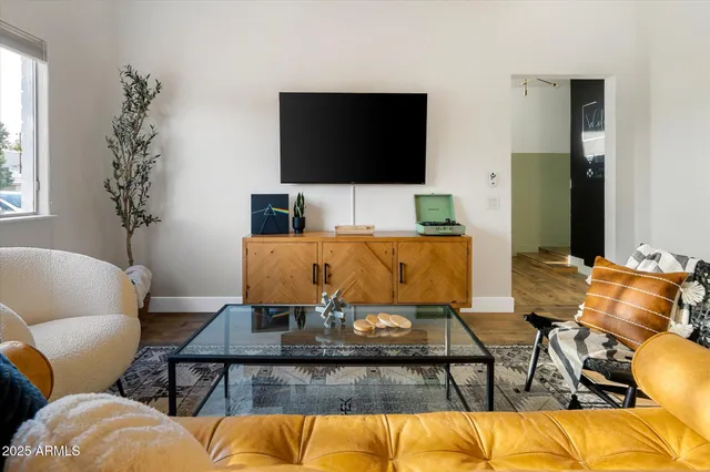 a living room with furniture and a flat screen tv