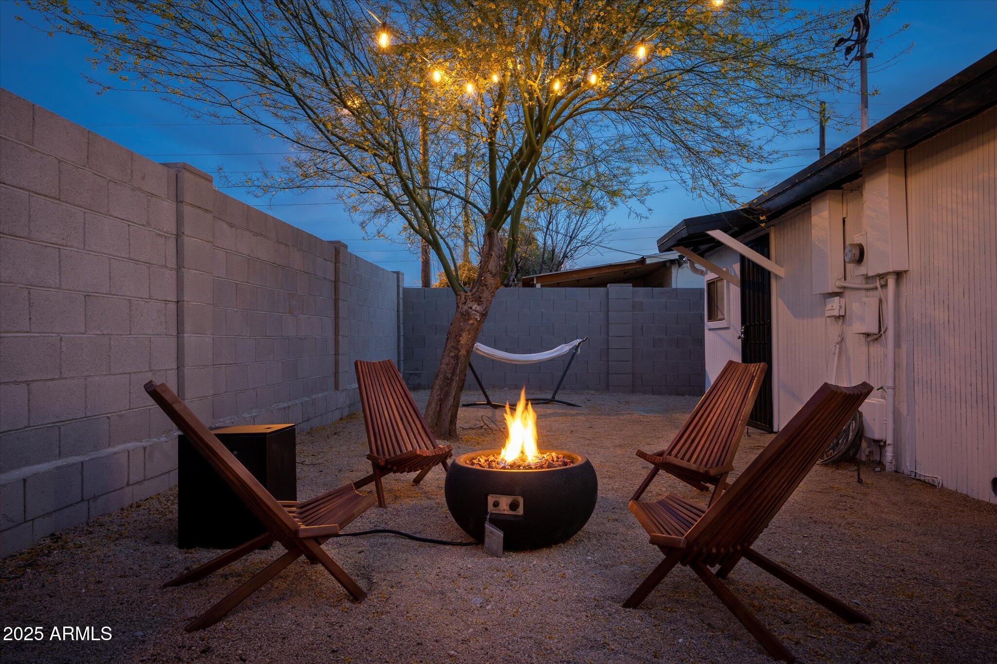 2307 North 51st Place Phoenix, AZ 85008 - Photo 38 of 41 a view of a backyard with chairs and a fire pit
