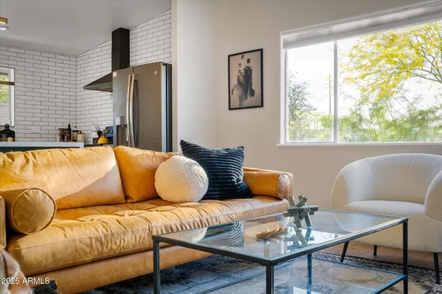 a living room with furniture and a large window
