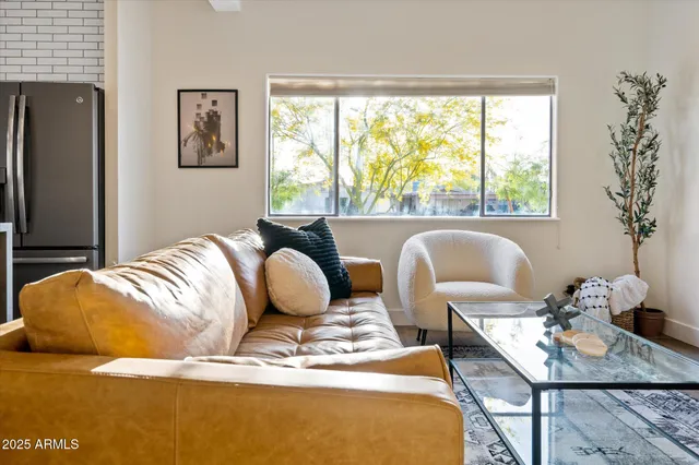 a living room with furniture rug and a large window